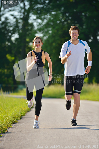 Image of Young couple jogging at morning