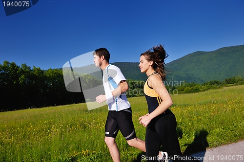 Image of Young couple jogging