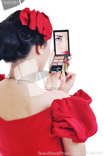 Image of beautiful young woman applying makeup