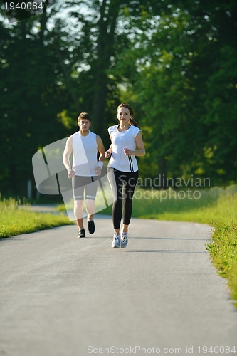 Image of Young couple jogging at morning