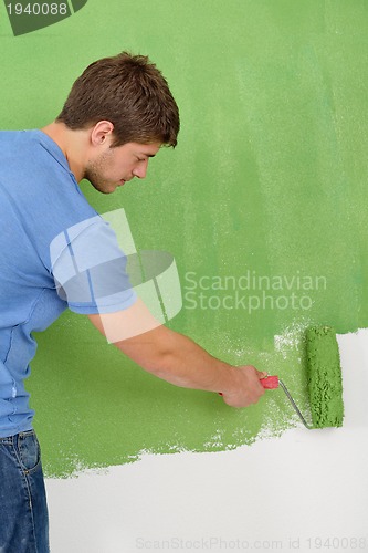 Image of happy couple paint wall at new home