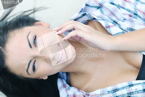 Image of beautiful young lady posing in garden
