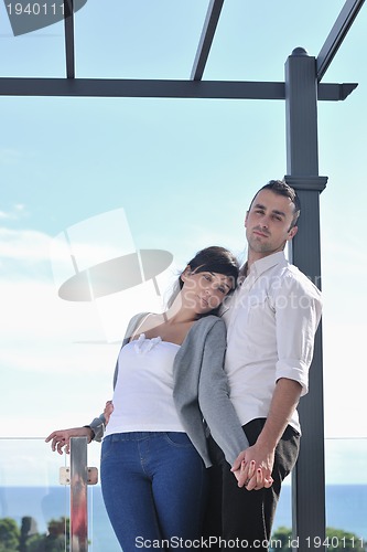 Image of couple relaxing on balcony