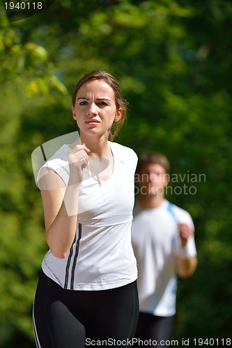 Image of Young couple jogging at morning