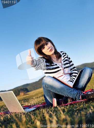 Image of young teen girl work on laptop outdoor