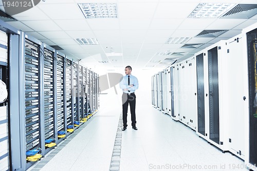 Image of young it engeneer in datacenter server room