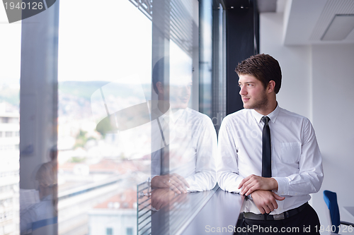 Image of happy young business man at office