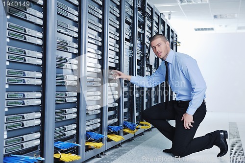 Image of young it engineer in datacenter server room