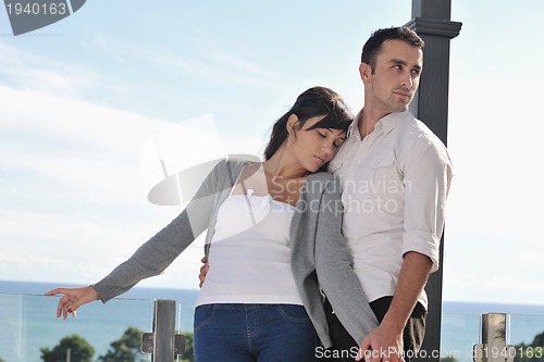 Image of couple relaxing on balcony