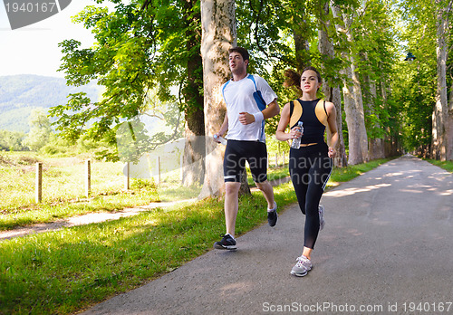 Image of Young couple jogging