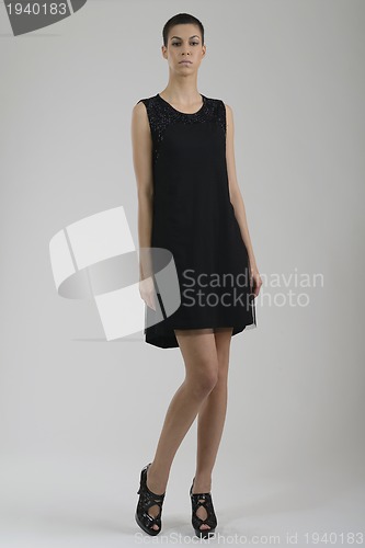 Image of elegant woman in fashionable dress posing in the studio