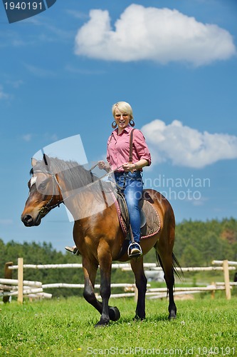 Image of happy woman  on  horse