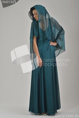 Image of elegant woman in fashionable dress posing in the studio