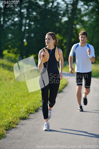 Image of Young couple jogging at morning