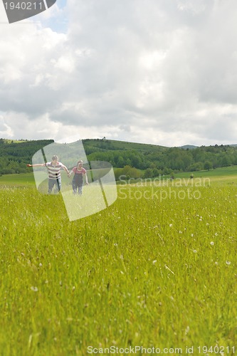 Image of Portrait of romantic young couple smiling together outdoor