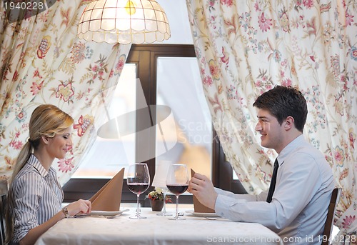 Image of young couple having dinner at a restaurant