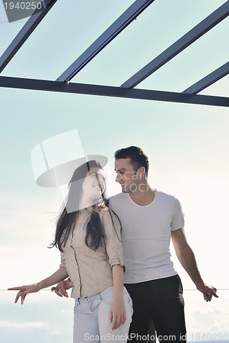 Image of couple relaxing on balcony