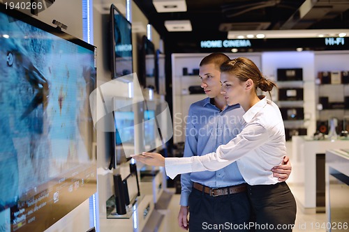 Image of Young couple in consumer electronics store