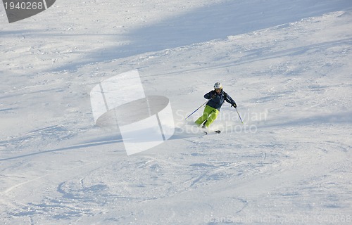 Image of skiing on fresh snow at winter season at beautiful sunny day