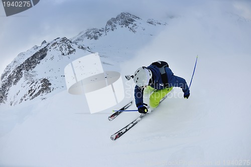 Image of skiing on fresh snow at winter season at beautiful sunny day