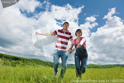 Image of Portrait of romantic young couple smiling together outdoor