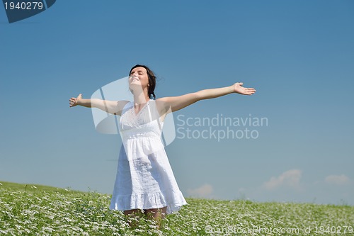 Image of Young happy woman in green field
