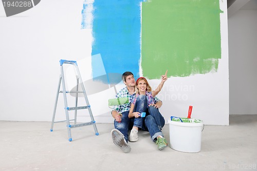 Image of happy young cople relaxing after painting in new home