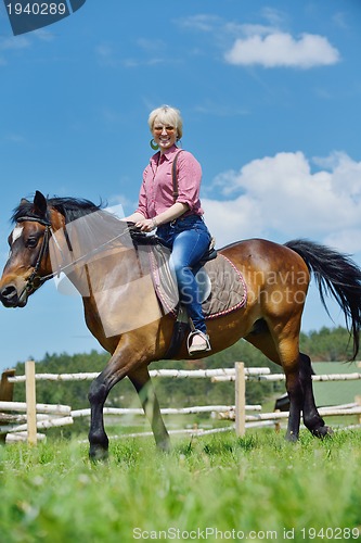 Image of happy woman  on  horse