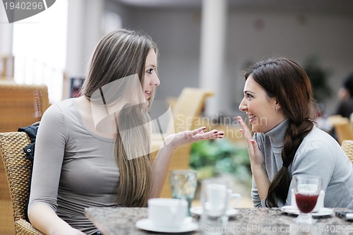 Image of cute smiling women drinking a coffee