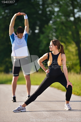 Image of Couple doing stretching exercise  after jogging