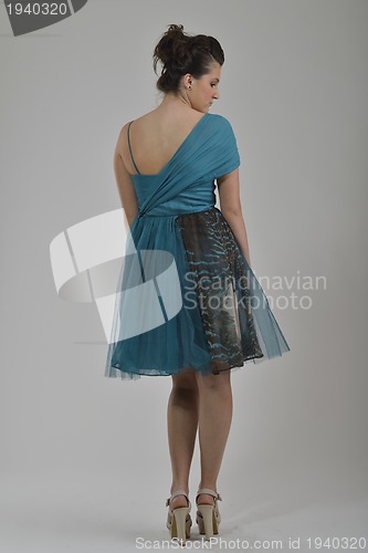 Image of elegant woman in fashionable dress posing in the studio
