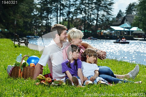 Image of Happy family playing together in a picnic outdoors