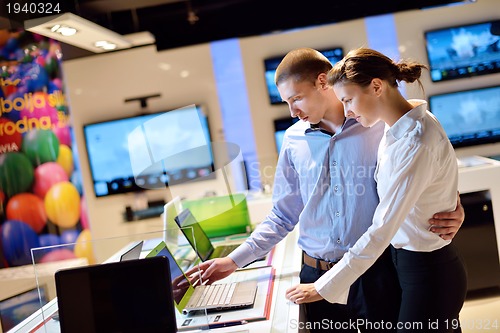 Image of Young couple in consumer electronics store