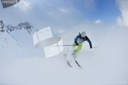 Image of skiing on fresh snow at winter season at beautiful sunny day