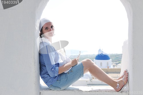 Image of Greek woman on the streets of Oia, Santorini, Greece