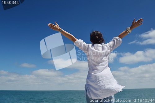 Image of happy young woman with spreading arms to sky