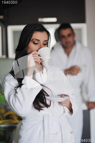 Image of Young love couple taking fresh morning cup of coffee