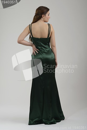 Image of elegant woman in fashionable dress posing in the studio