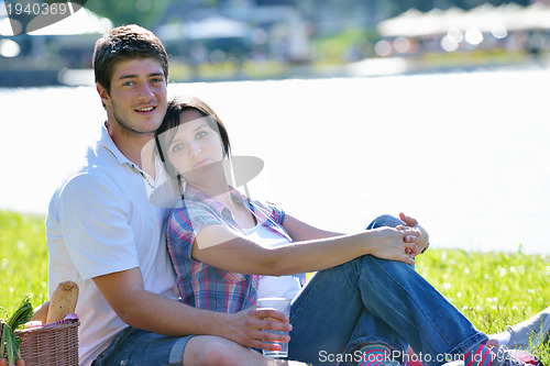 Image of happy young couple having a picnic outdoor