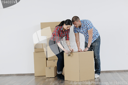 Image of Young couple moving in new house