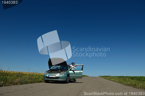 Image of woman with broken car