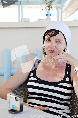 Image of Greek woman on the streets of Oia, Santorini, Greece