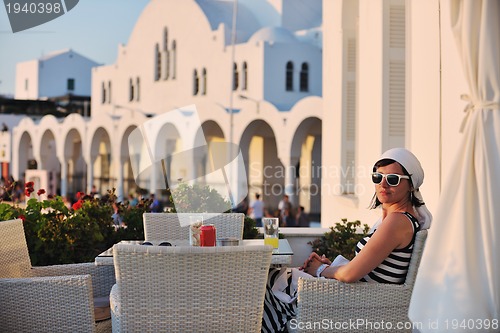 Image of Greek woman on the streets of Oia, Santorini, Greece