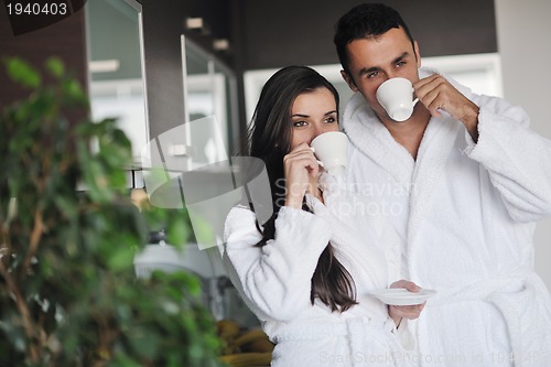 Image of Young love couple taking fresh morning cup of coffee