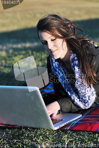 Image of young teen girl work on laptop outdoor