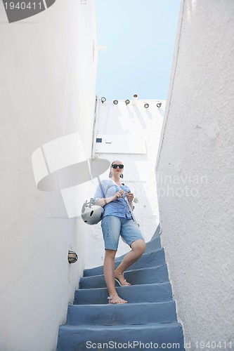 Image of Greek woman on the streets of Oia, Santorini, Greece