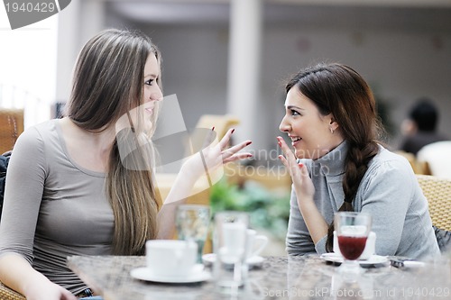 Image of cute smiling women drinking a coffee