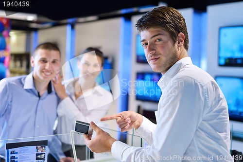 Image of Young couple in consumer electronics store