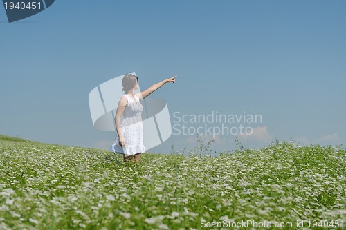 Image of Young happy woman in green field