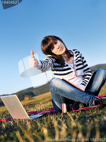 Image of young teen girl work on laptop outdoor